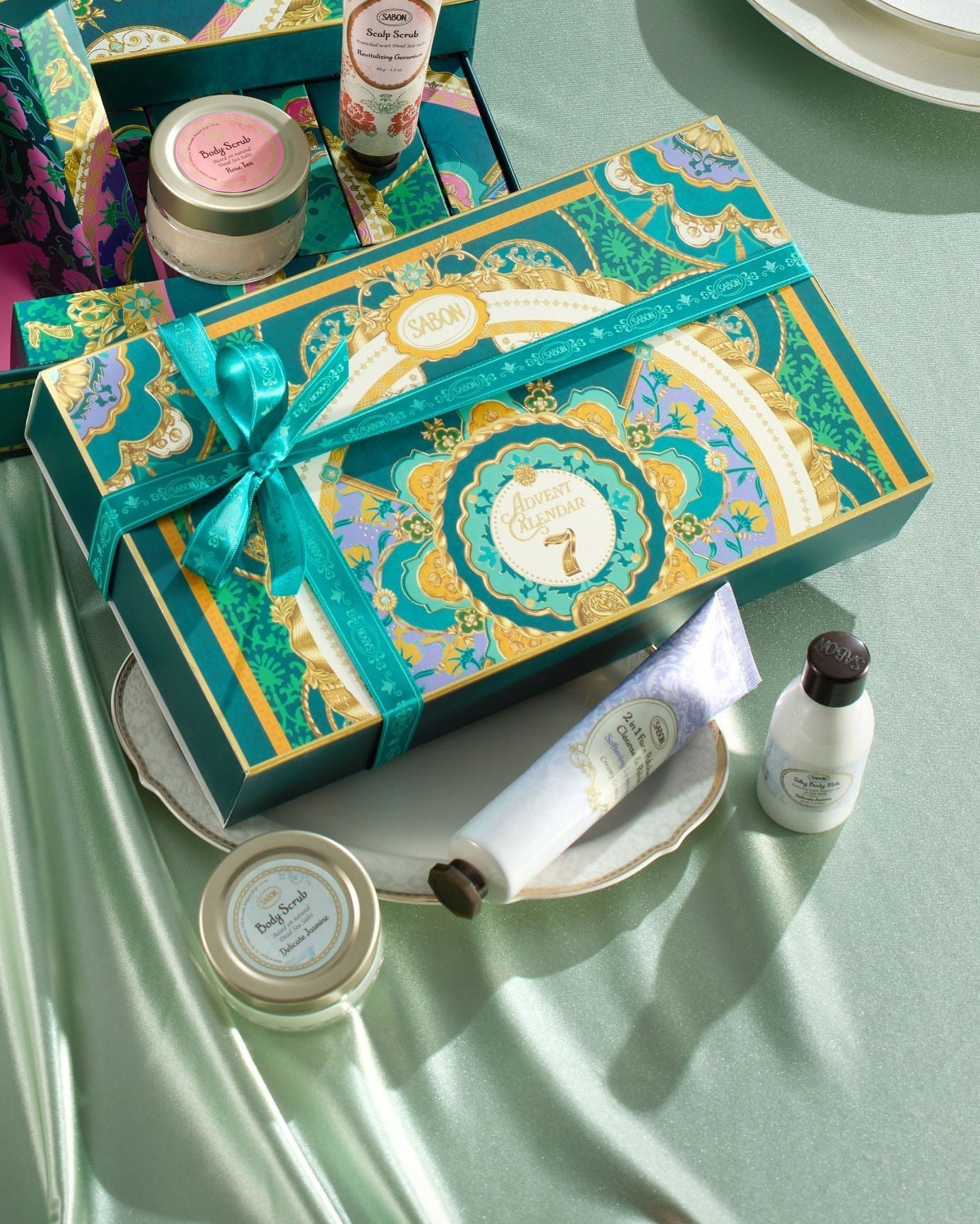Cosmetic advent calendar with various products on a light green surface