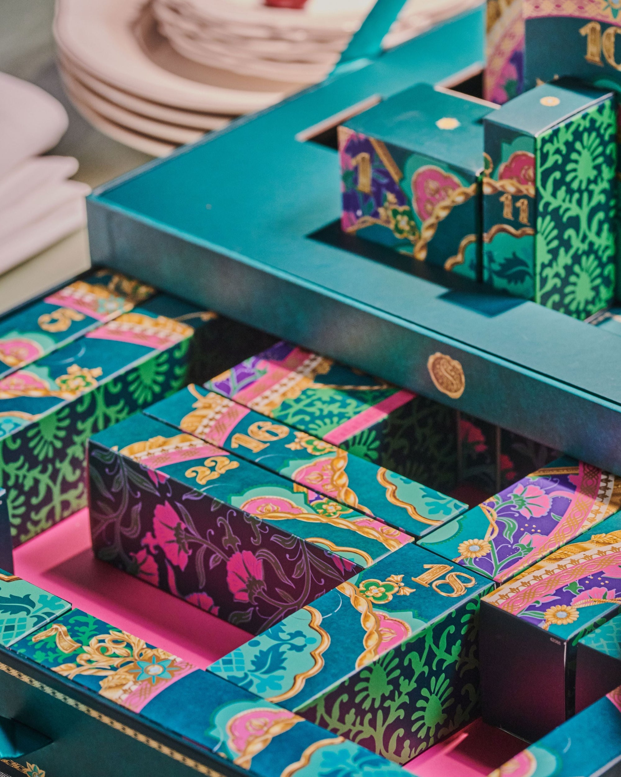 Colorful patterned boxes with a blue display stand