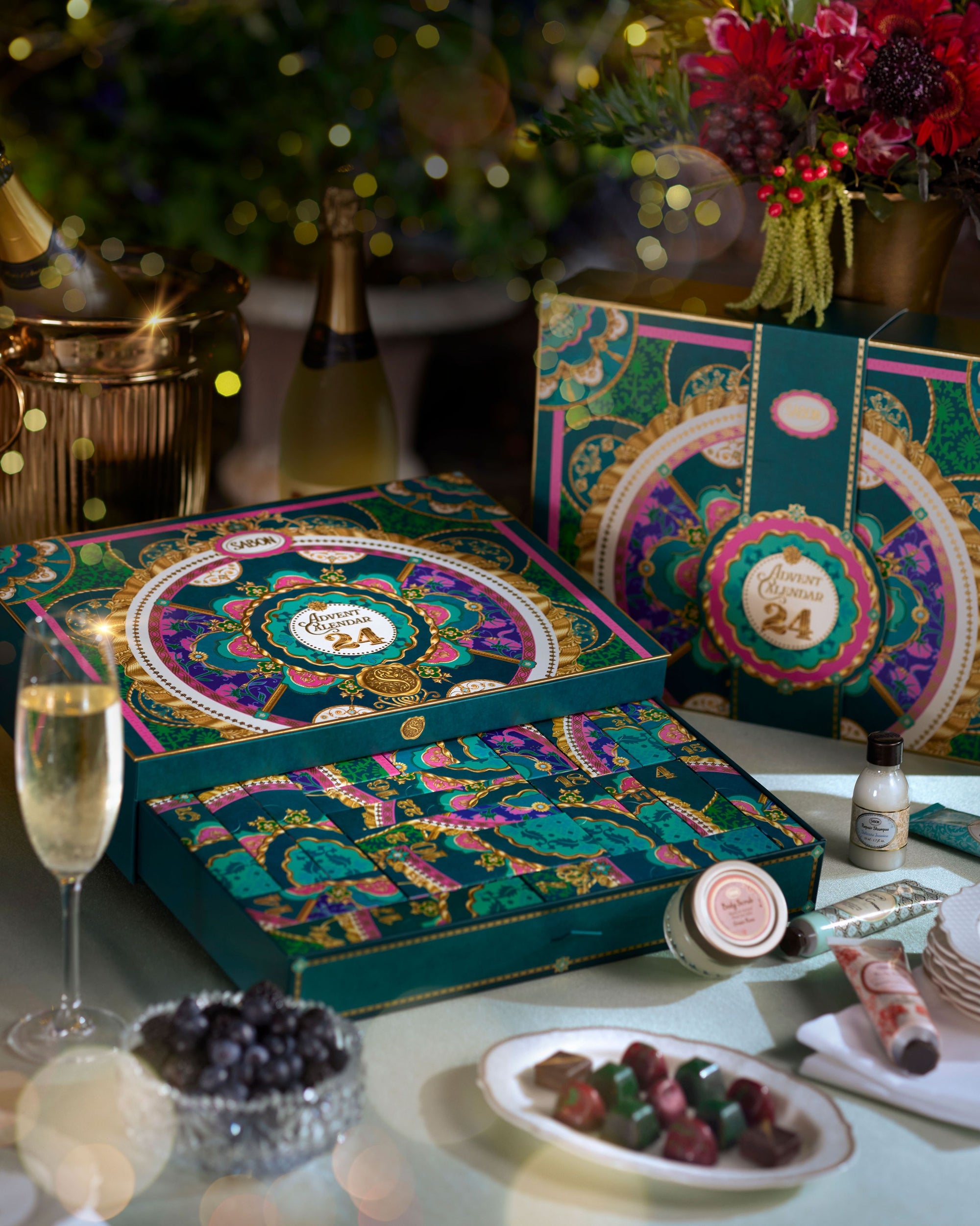 Decorative advent calendar with festive design on a table with champagne and snacks.